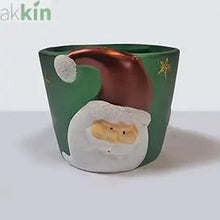 Green ceramic Christmas planter with raised Santa design