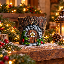 Cement Christmas fairy house with yellow star in a festive woodland display