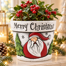 Cement Father Christmas planter styled with festive greenery