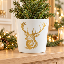 White ceramic gold stag planter in a warm festive home setting