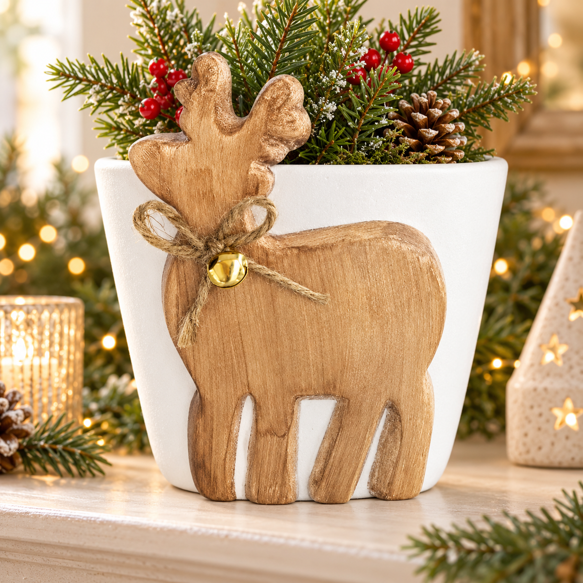 Ceramic reindeer planter with bell in a festive display