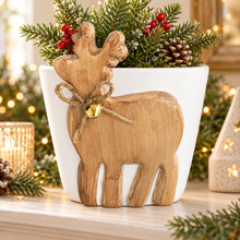 Ceramic reindeer planter with bell in a festive display