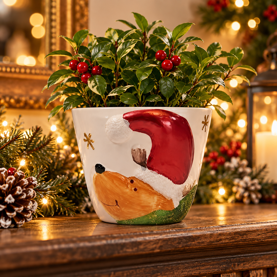 Ceramic reindeer with Santa hat planter in a festive display