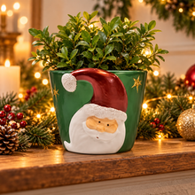 Ceramic Santa Christmas planter with festive greenery