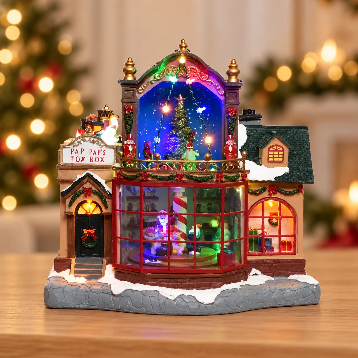 LED Christmas Toy Shop Scene Polyresin Indoor Decoration L.19cm W.30.5cm H.28.5cm – full product in a festive home setting