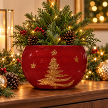 Red ceramic Christmas planter with gold tree and festive greenery