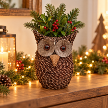 Rustic woven owl planter with festive greenery in a warm Christmas display