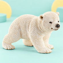 Schleich - Polar Bear Cub Walking shown in full on a pale teal studio background